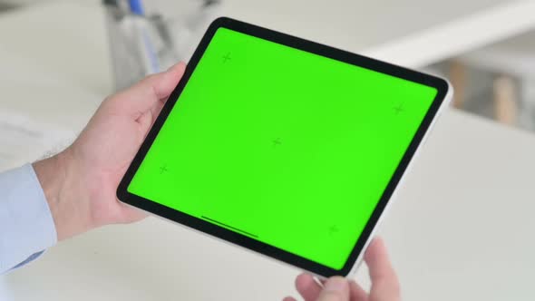 Middle Aged Man Using Tablet with Green Chroma Screen alt