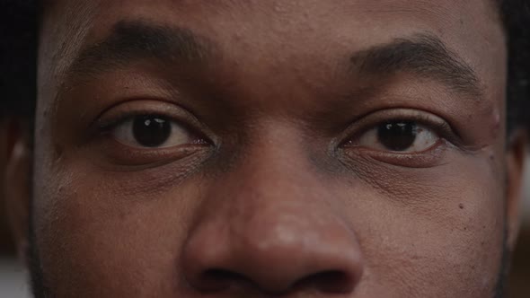 Extreme Closeup of a Surprised Africanamerican Man's Eyes Open an Raise the Eyebows alt