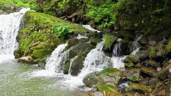 Mountain River Waterfall Flowing Between Rocky Shores in Carpathians Mountains Ukraine alt