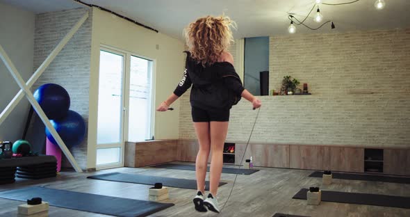 Perfect Looking Blonde Woman Using a Rope To Get alt