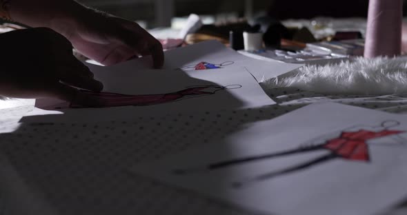 Close up of Male designer looking contemplating drawings alt