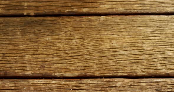 Hands of woman holding rock salt and black paper over wooden platform 4k alt