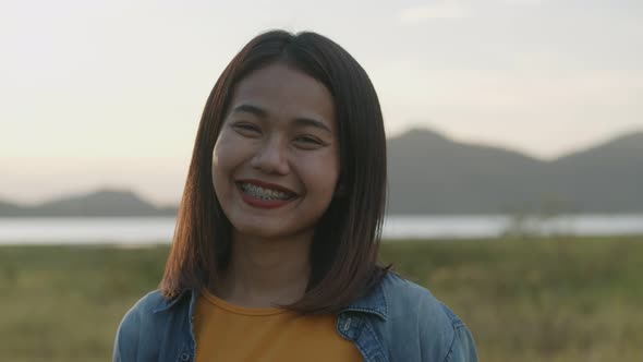 Portrait of beautiful young Asian woman smiling look at camera.