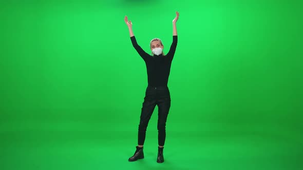 Female Dancing at a Concert Woman in Protective Medical Mask at a Music Concert Dance and Claps alt