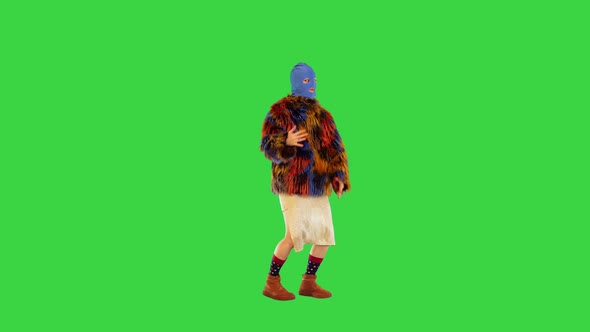 Young Girl in Blue Balaclava and Faux Fur Coat Dancing on a Green Screen Chroma Key