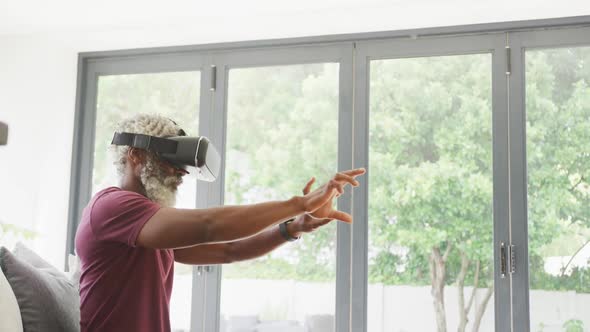 Video of african american senior man using vr headset alt