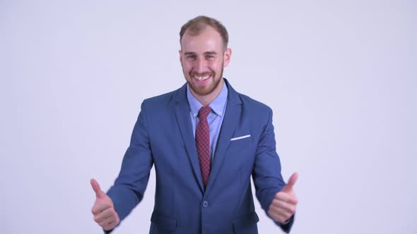 Happy Bearded Businessman Giving Thumbs Up and Looking Excited
