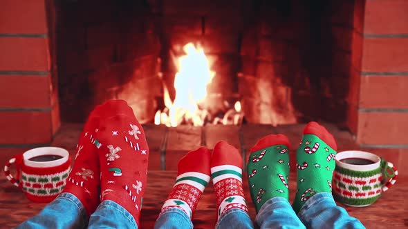 Family In Christmas Socks Near Fireplace. Mother; Father And Child Having Fun