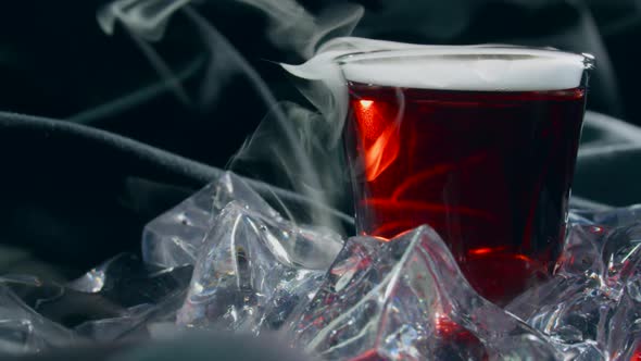Red Cocktail with Smoking Dry Ice alt