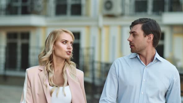 Closeup Couple Walking Together at Street. Business Partners Discussing Work alt