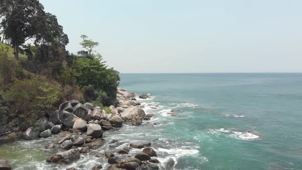 Waves washing on coastline rocks. Aerial of tropical Phuket Adamant sea alt