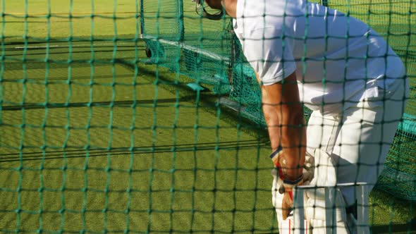 Cricket players practicing in the nets during a practice session alt