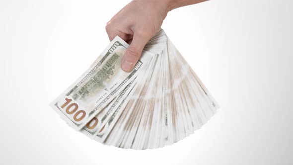Hand on a White Background of Isolate Holds One Hundred Dollar Bills and Moves a Stack of American alt