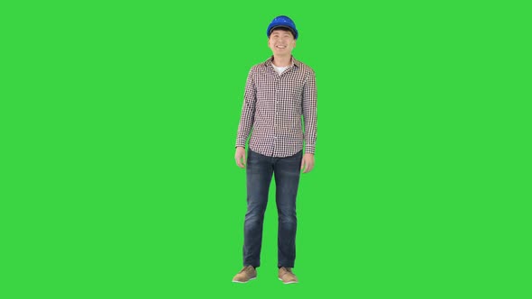 Engineer in a Safety Helmet Smiling on Camera on a Green Screen Chroma Key
