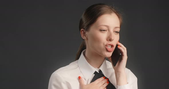 Yong Manager Woman in Business Suit Has a Business Talk with Client Via Mobile Phone Work with alt