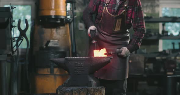 The Blacksmith Hits the Redhot Metal with a Hammer