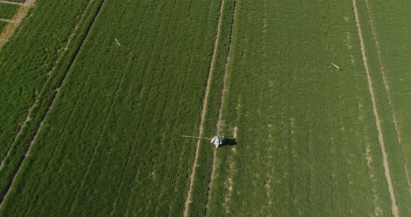 Agricultural Researcher Spraying Filed with Herbicides or Pesticides alt