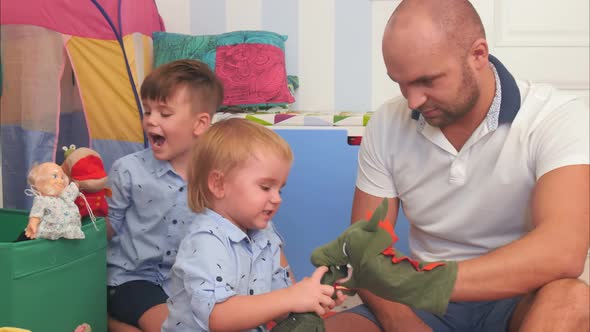 Happy Parents and Two Little Boys Playing with Puppets alt