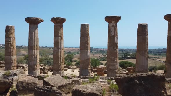 Ancient Roman columns standing tall, ruins from historic empire building, aerial alt