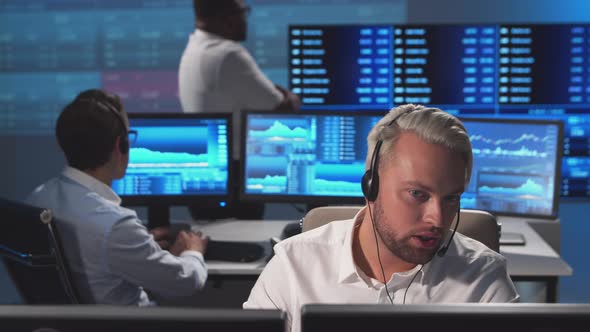 Diverse team of brokers workin in office using workstation and analysis technology. alt