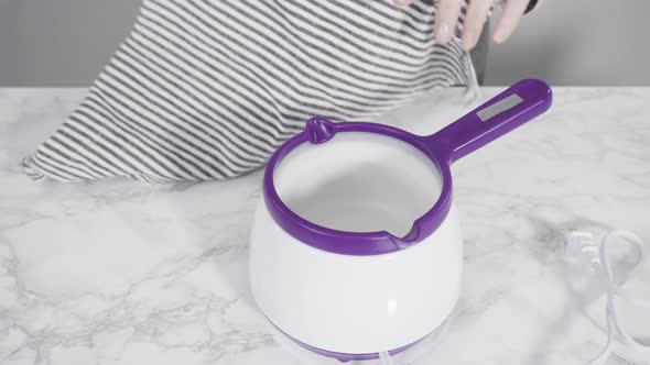 Step by step. Melting red chocolate chips for chocolate molded shapes. alt