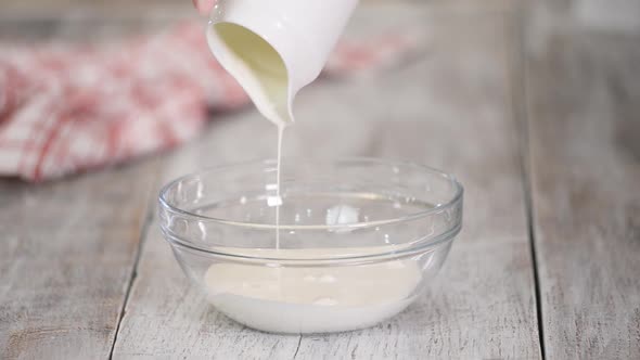 Whipping of Cream in a Glass Bowl with Mixer, Slow Motion alt