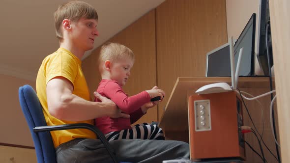 Boy With Dad At The Computer alt