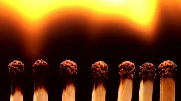 Burning matches on a black background. alt