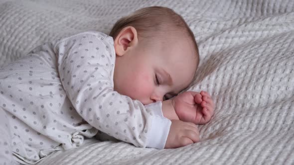 Peaceful Adorable Baby Sleeping on His Bed in a Room at Home alt