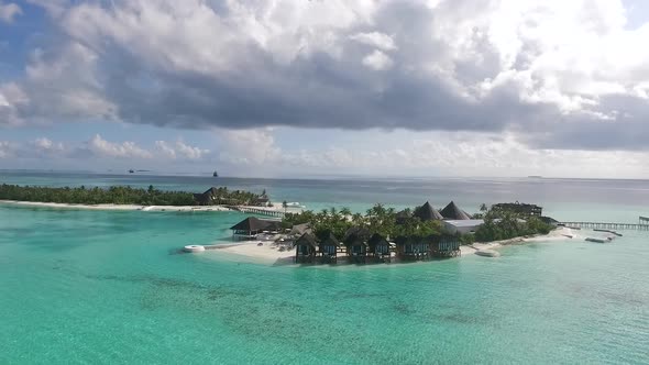 Drone shot of a Maldives island with dramatic clouds Full HD alt