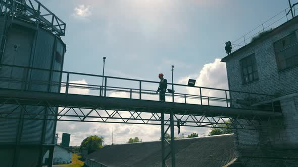 Agronomist Farmer Checking Grain Soybean and Wheat Storage Tanks alt