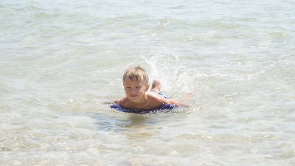 Closeup of a Happy Boy Swimming in the Purest Azure Sea in Shallow Water