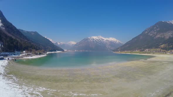 Breathtaking View of Grand Snowy Mountains, Clear Blue Sky, Beautiful Lake alt