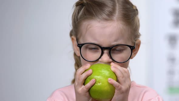 Smiling Little Girl Eyeglasses Eating Green Apple, Healthy Nutrition, Vitamins alt