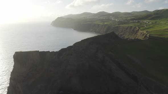 Aerial View of cliff overlooking the ocean, Baìa de Entre Morros, Velas, Azores. alt