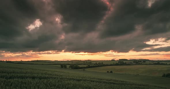 Green Fields Time Lapse With Moody Sunset Clouds Rolling Sideways