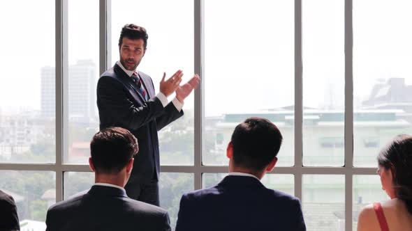 Boss of the company coach gives corporate presentation for businesspeople in office