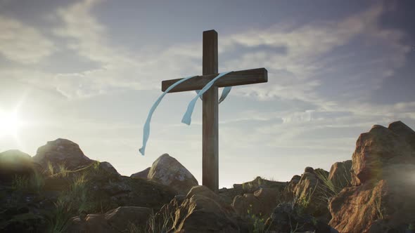 Cross of Jesus Christ on Rocky Hill at Sunset
