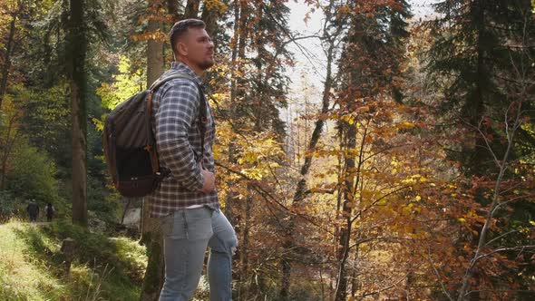 Male Backpacker is Traveling in Natural Reserve alt