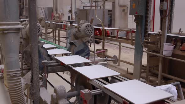 Factory for the production of ceramic tiles on conveyor belt. alt