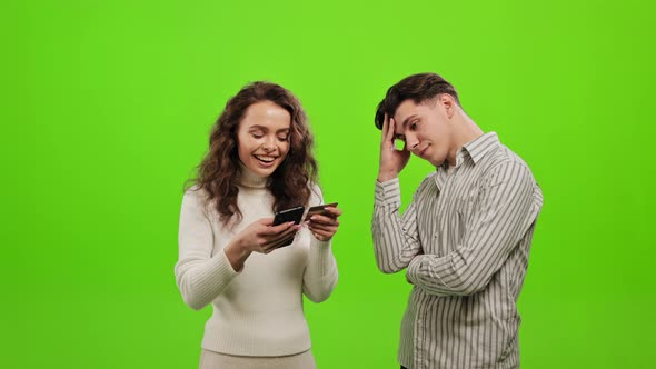 The Woman is Entering His Bank Card Details Into Her Smartphone alt