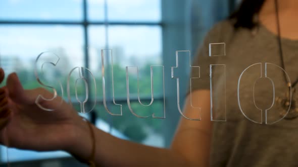 Woman Holding Glass Solution Sign alt