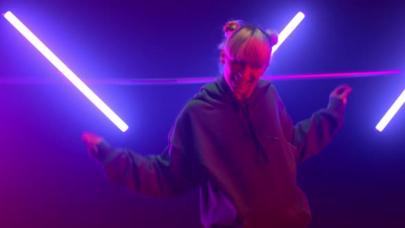Woman Dancing Freestyle Hip Hop in Neon Lights alt