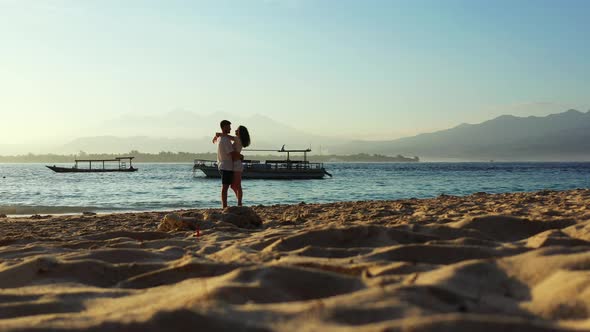 Young couple in love dating on vacation enjoy life on beach on clean white sand background 4K alt