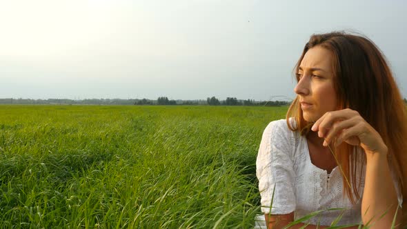Beautiful Young Woman Enjoying Nature in Summer Evening. Portrait Happy Young Woman