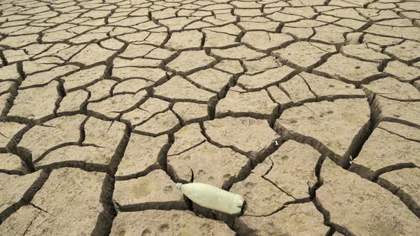 Bottom of the Empty Studena Dam with Empty Plastic Bottle on the Cracked Earth, Bulgaria alt