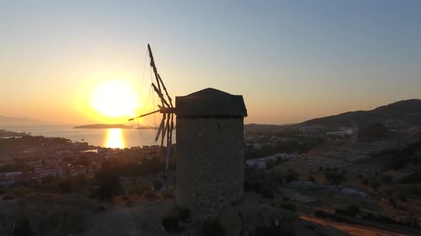 Old Traditional Historic Stone Windmill by the Sea at the Sunset