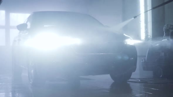 Washing of Vehicle with Turned on Headlight in Auto Care Shop. Cleaning of Automobile with Manual alt