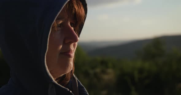 A Young Woman in a Hood Looks Ahead alt