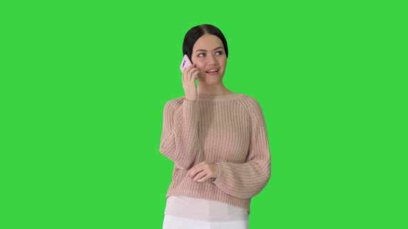 Emotional Smiling Young Woman Talking on the Phone and Gesturing on a Green Screen Chroma Key alt